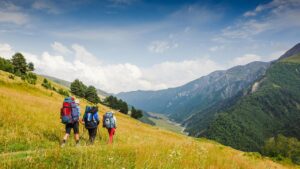 A group of people walking up the side of a hill.