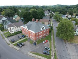 An aerial view of a building with cars parked in front.