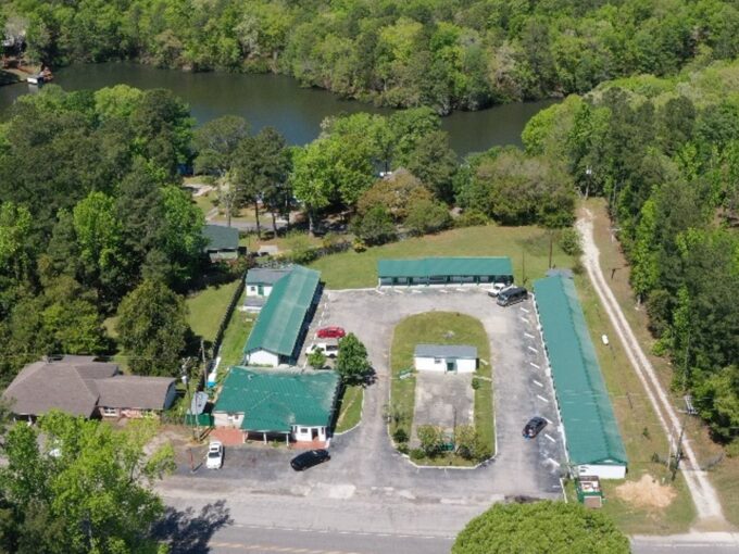 An aerial view of a parking lot with several buildings.