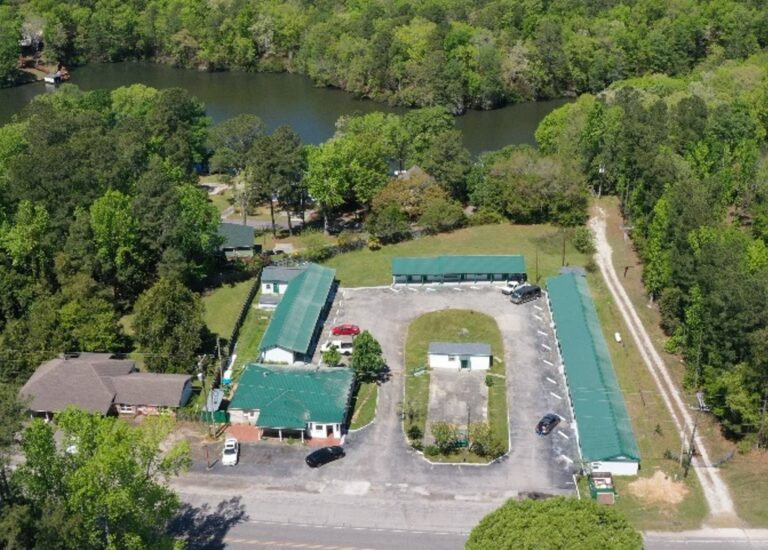 An aerial view of a parking lot with several buildings.